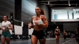 Woman holding a medicine ball considering hyrox race nutrition