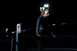 Woman lifting weights with a Marchon bottle filled with creatine monohydrate