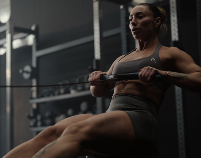 A woman doing seated rows in the gym after taking vitamin D supplements